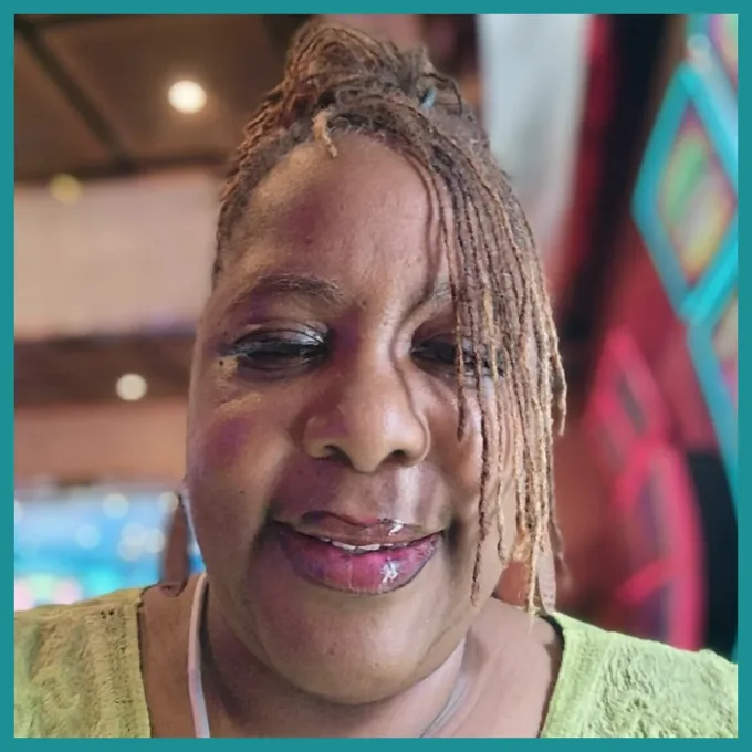 Damita Cleveland, founder of LeJean Travels, smiling headshot with turquoise frame.
